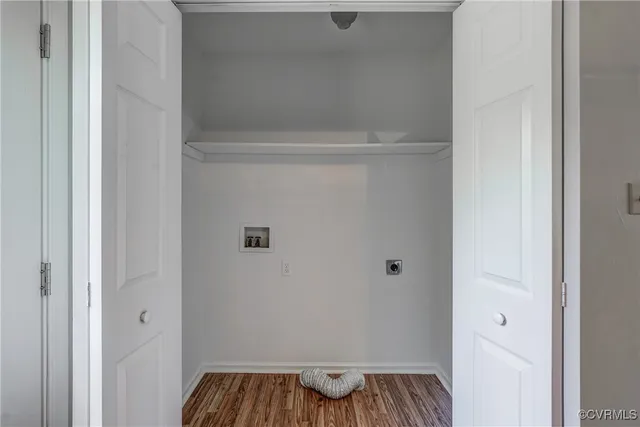 a view of walk in closet with wooden floor