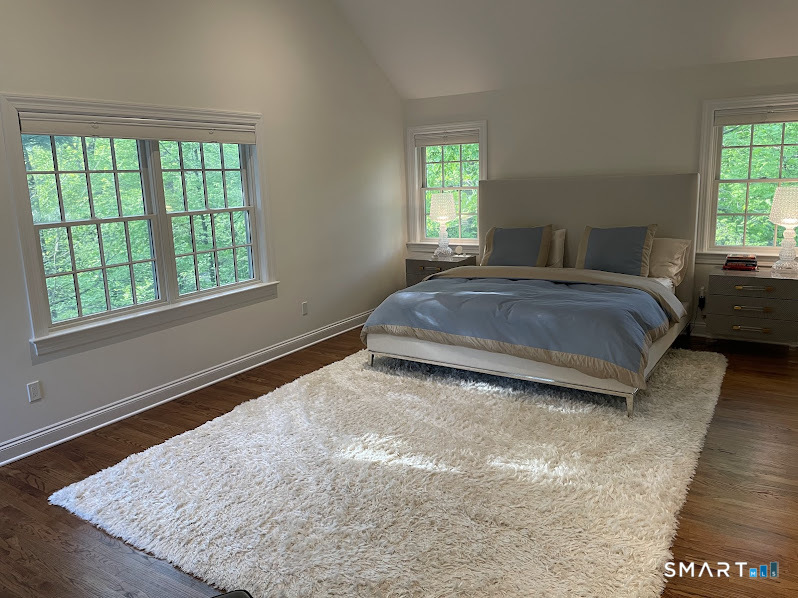 9 Tory Hole Road Darien, CT 06820 - Photo 14 of 33 a spacious bedroom with a bed and window