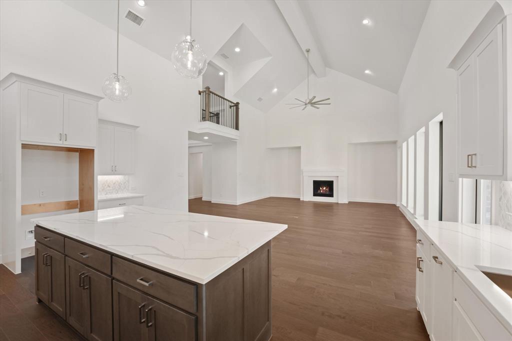 4626 Rillstone Road Midlothian, TX 76065 - Photo 11 of 40 Kitchen featuring beam ceiling, high vaulted ceiling, a ceiling fan, white cabinets, and dark wood-style flooring