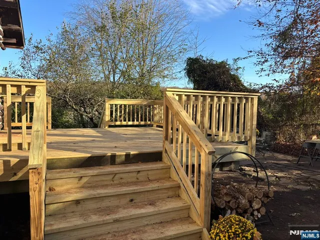a view of a brick house with wooden fence