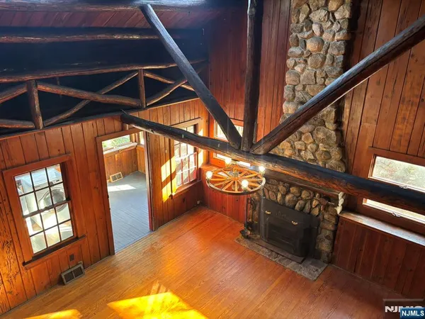 a living room with couches rug and a floor to ceiling window