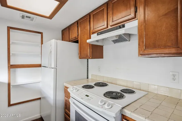 a kitchen with a refrigerator and a stove