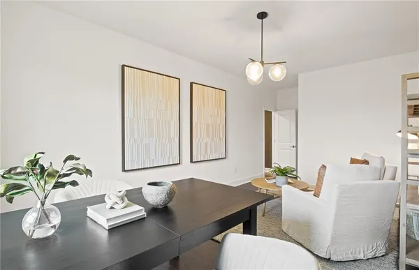 a view of a dining room with furniture wooden floor and chandelier