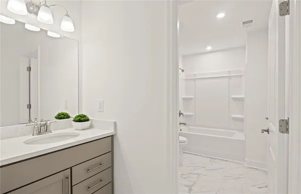 a bathroom with a double vanity sink and a mirror