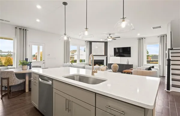 a kitchen with center island a sink appliances and a counter top space