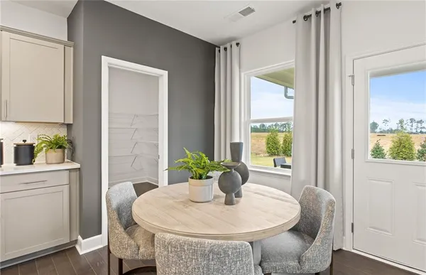 a dining room with furniture and wooden floor