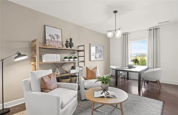 a living room with furniture a rug and a window