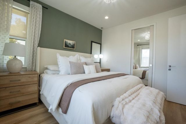 a bed room with a bed and mirror