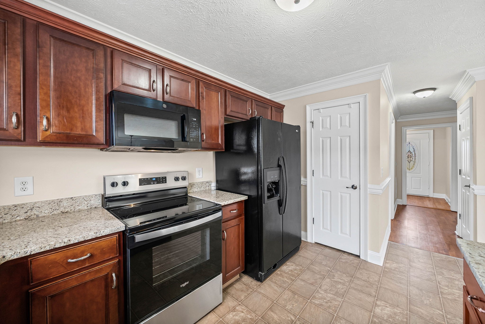 135 Excell Road, Unit 102 Clarksville, TN 37043 - Photo 11 of 24 a kitchen with granite countertop wooden cabinets stainless steel appliances and a counter space