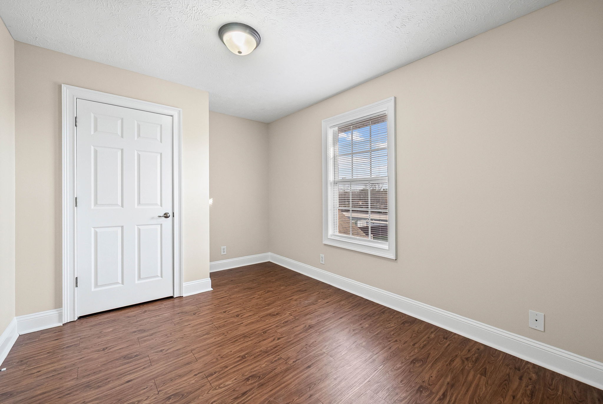 135 Excell Road, Unit 102 Clarksville, TN 37043 - Photo 17 of 24 an empty room with wooden floor and windows