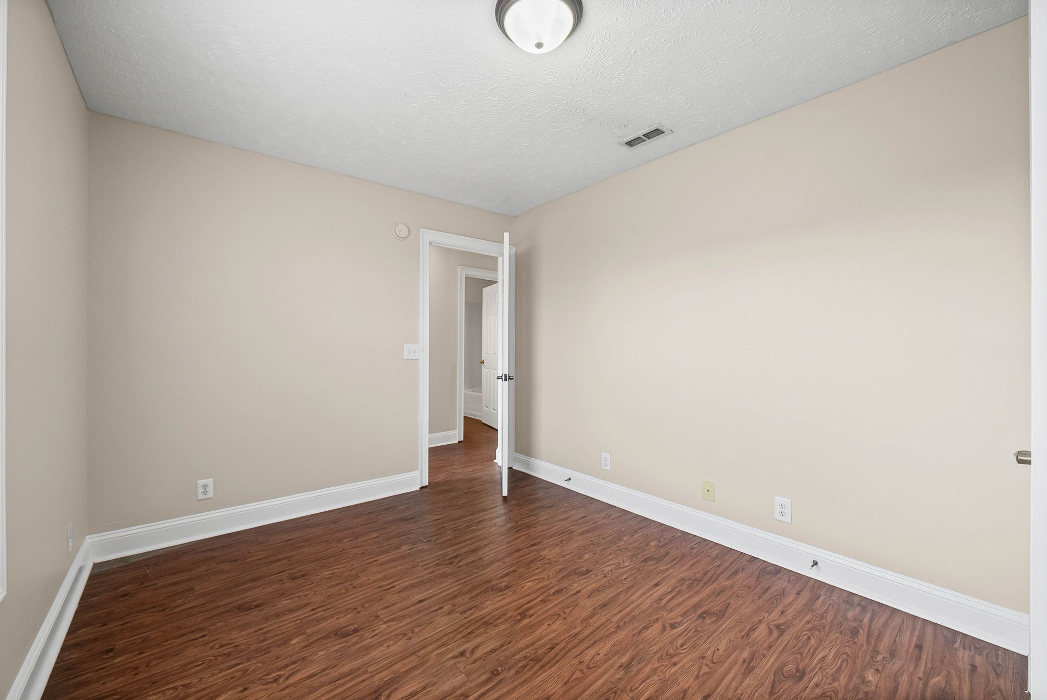 135 Excell Road, Unit 102 Clarksville, TN 37043 - Photo 18 of 24 a view of an empty room with wooden floor and windows