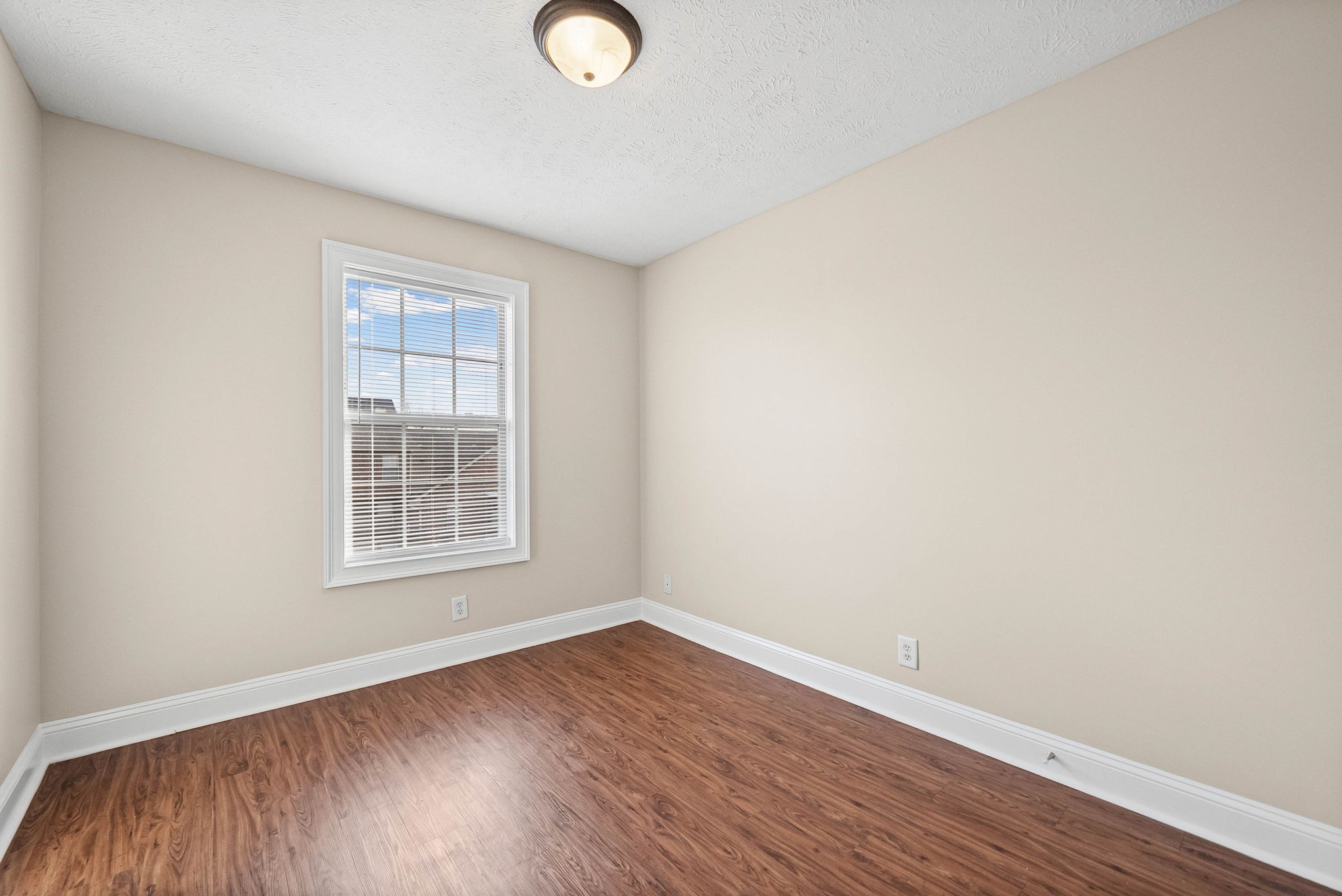 135 Excell Road, Unit 102 Clarksville, TN 37043 - Photo 20 of 24 an empty room with wooden floor and windows
