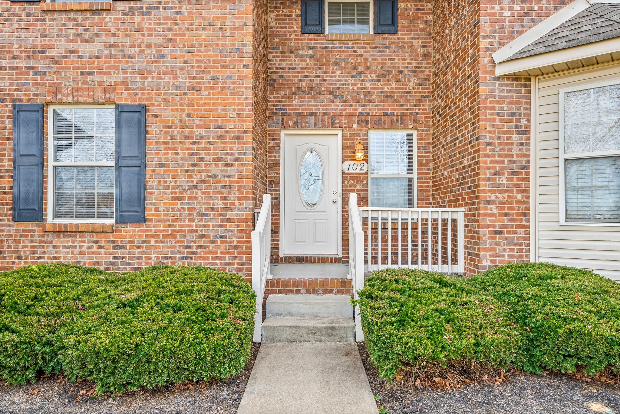 135 Excell Road, Unit 102 Clarksville, TN 37043 - Photo 2 of 24 a front view of a house with a lots of potted plants