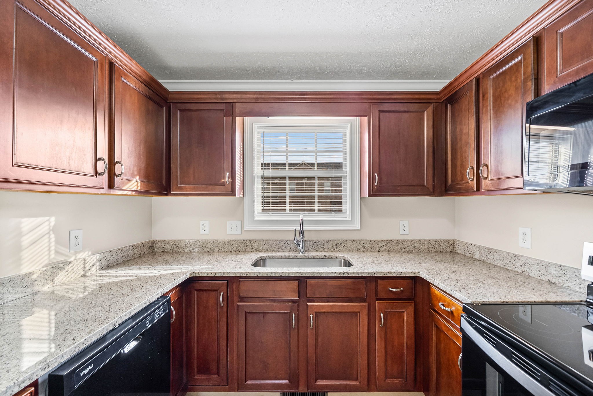 135 Excell Road, Unit 102 Clarksville, TN 37043 - Photo 10 of 24 a kitchen with granite countertop stainless steel appliances a sink window and cabinets