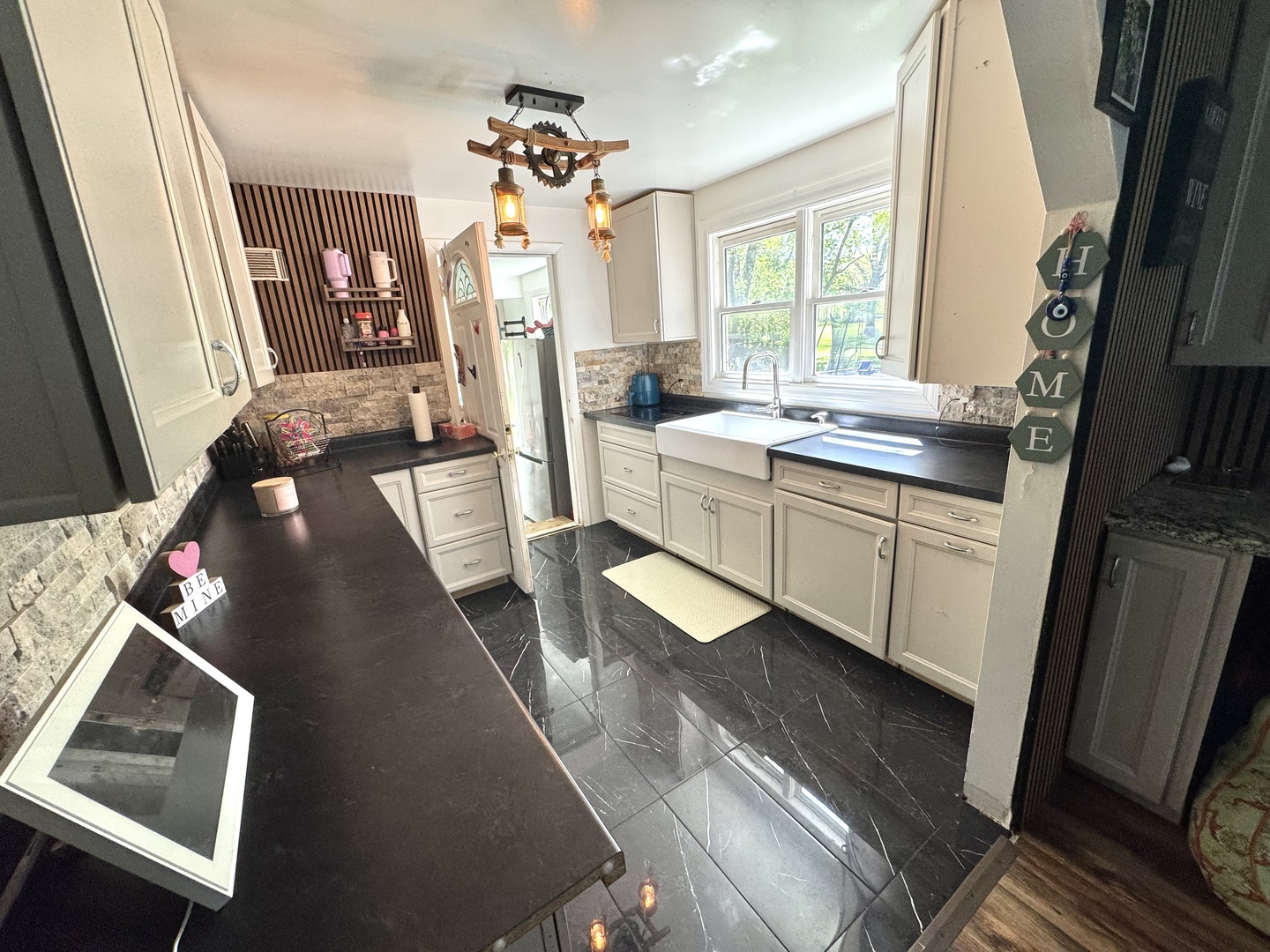 931 South Rawson Bridge Road Cary, IL 60013 - Photo 28 of 36 a large kitchen with a sink a window and stainless steel appliances