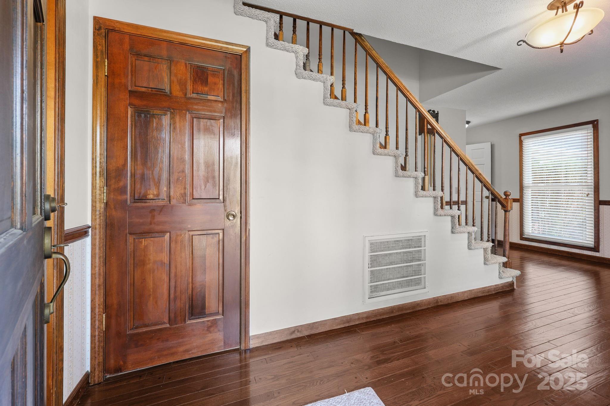 1202 Pineview Drive Albemarle, NC 28001 - Photo 12 of 41 a view of entryway with wooden floor and stairs