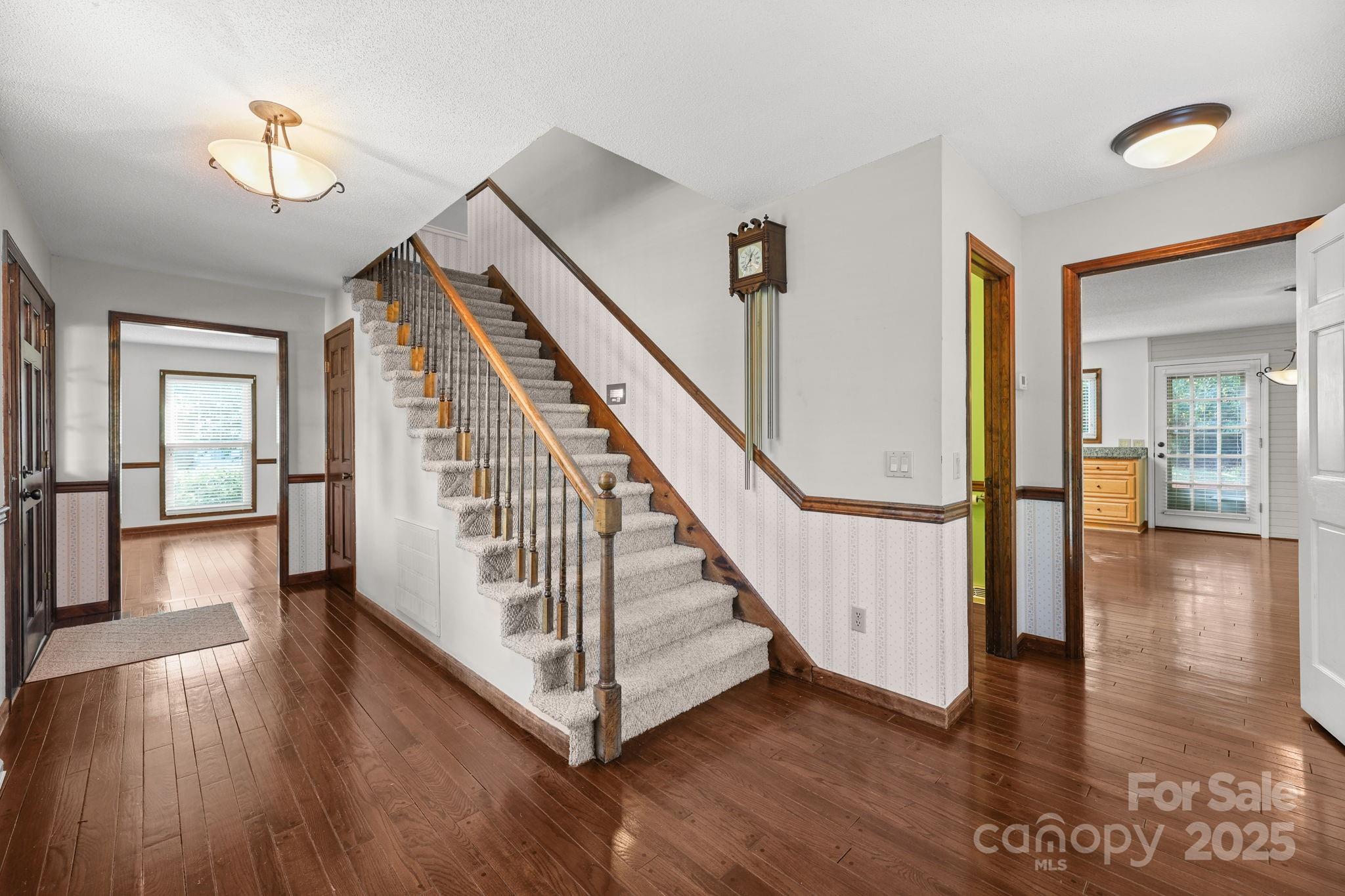 1202 Pineview Drive Albemarle, NC 28001 - Photo 13 of 41 a view of a hallway with wooden floor and staircase