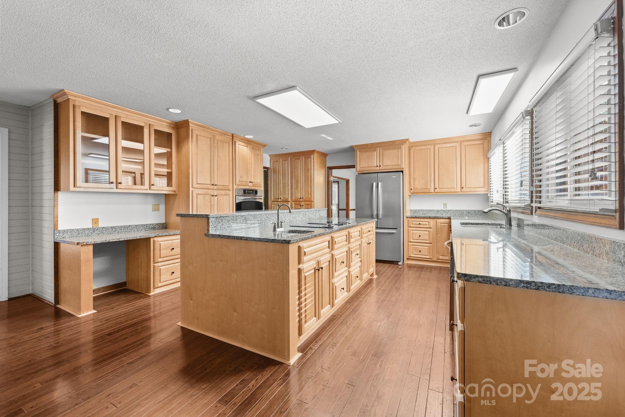 1202 Pineview Drive Albemarle, NC 28001 - Photo 3 of 41 a kitchen with stainless steel appliances granite countertop a stove a sink dishwasher a refrigerator and a oven with wooden floor