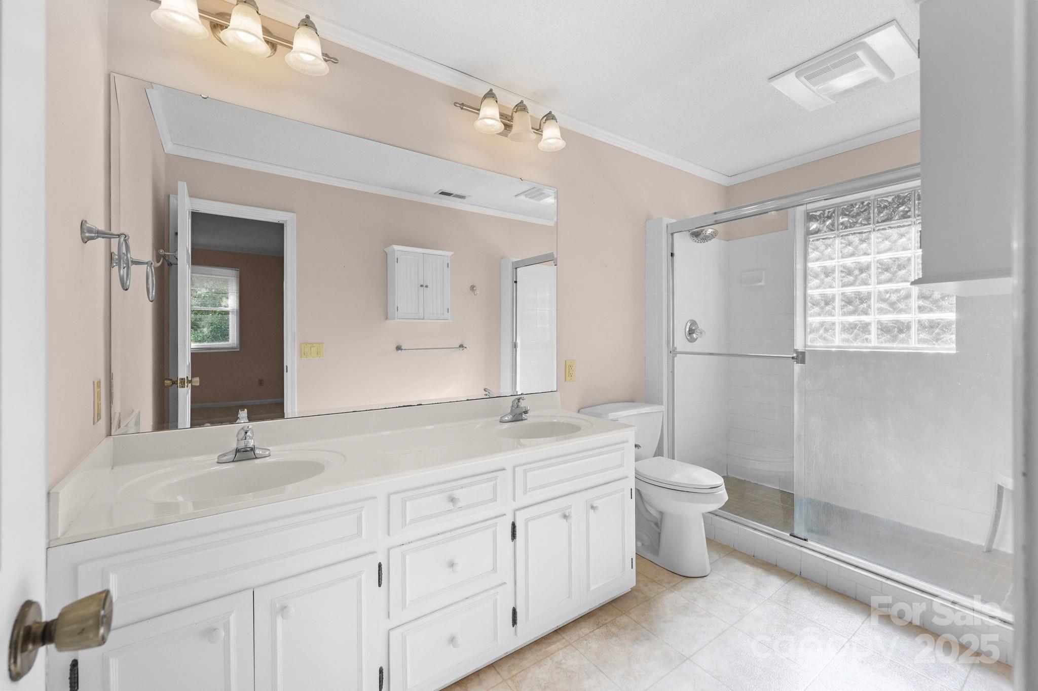 1202 Pineview Drive Albemarle, NC 28001 - Photo 40 of 41 a spacious bathroom with double sink a toilet a shower and a mirror