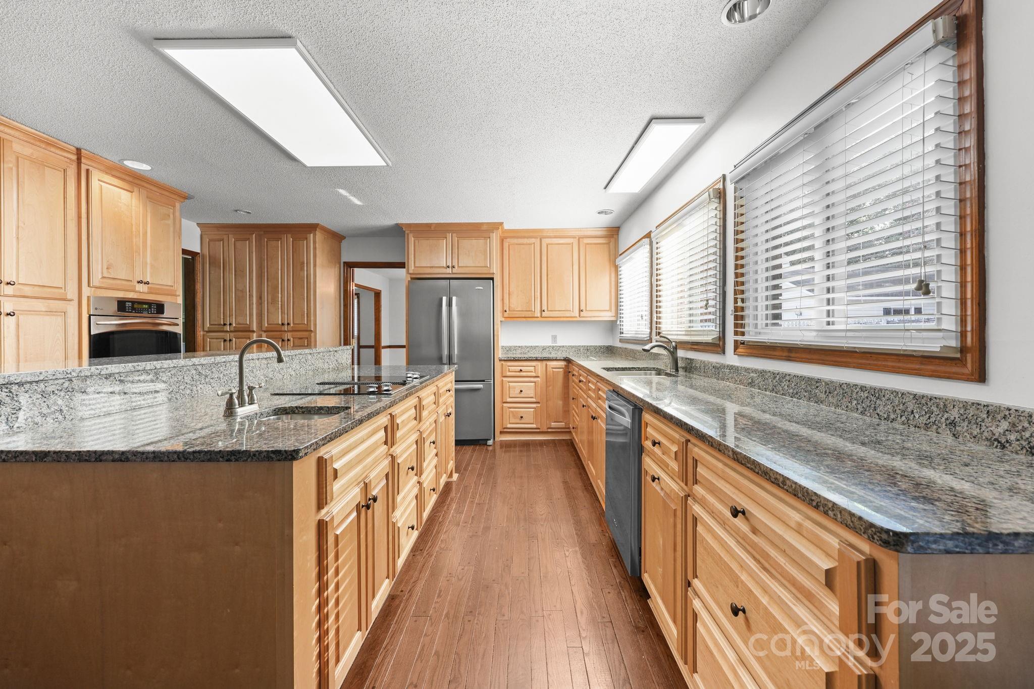 1202 Pineview Drive Albemarle, NC 28001 - Photo 4 of 41 a large kitchen with granite countertop a sink a counter space appliances and cabinets