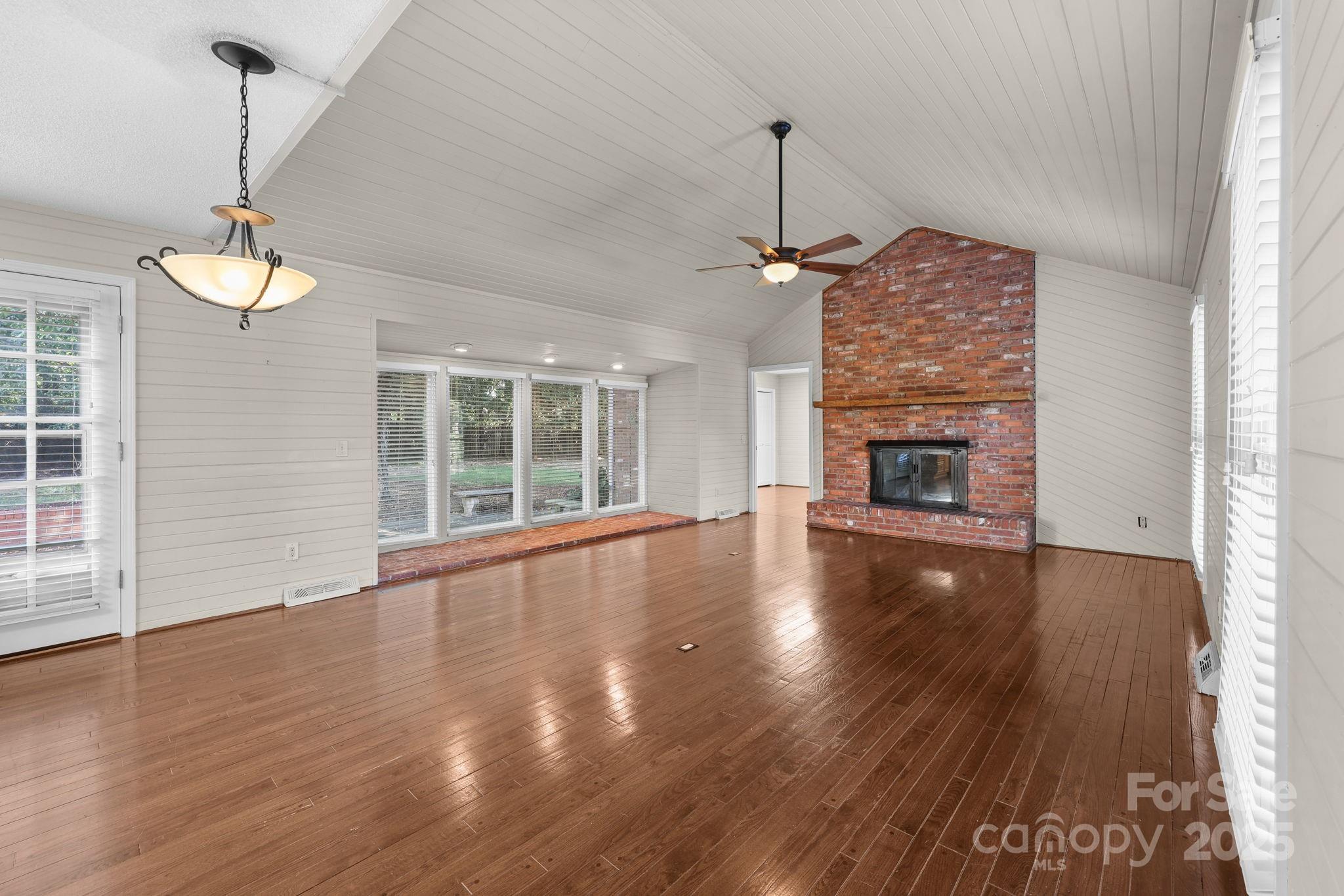 1202 Pineview Drive Albemarle, NC 28001 - Photo 10 of 41 a view of empty room with wooden floor fireplace and window