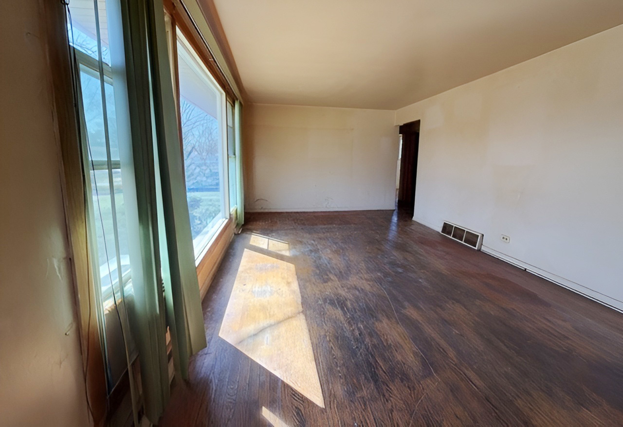 249 Eddy Street Chicago Heights, IL 60411 - Photo 2 of 10 an empty room with wooden floor and windows