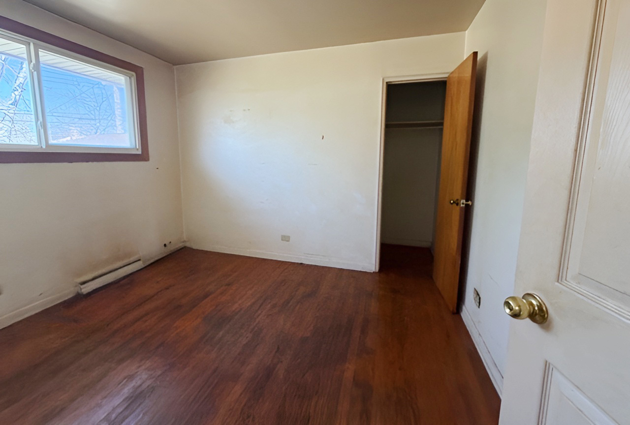 249 Eddy Street Chicago Heights, IL 60411 - Photo 5 of 10 a view of an empty room with wooden floor and a window