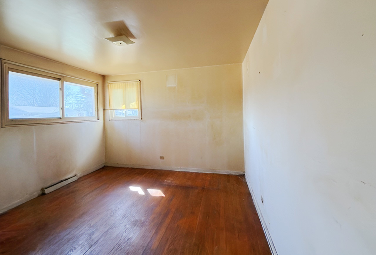 249 Eddy Street Chicago Heights, IL 60411 - Photo 6 of 10 an empty room with wooden floor and windows