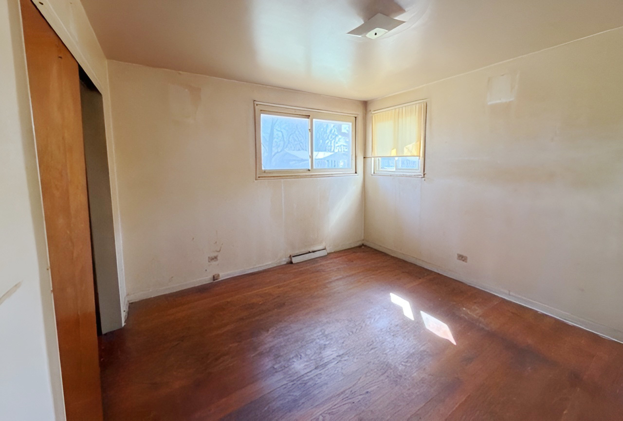 249 Eddy Street Chicago Heights, IL 60411 - Photo 7 of 10 an empty room with wooden floor and windows