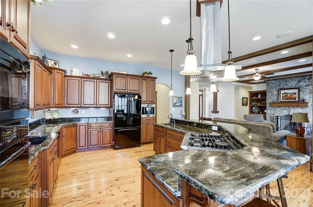 215 Eagle Cove Drive Cherryville, NC 28021 - Photo 12 of 48 a kitchen with stainless steel appliances granite countertop a sink stove and refrigerator
