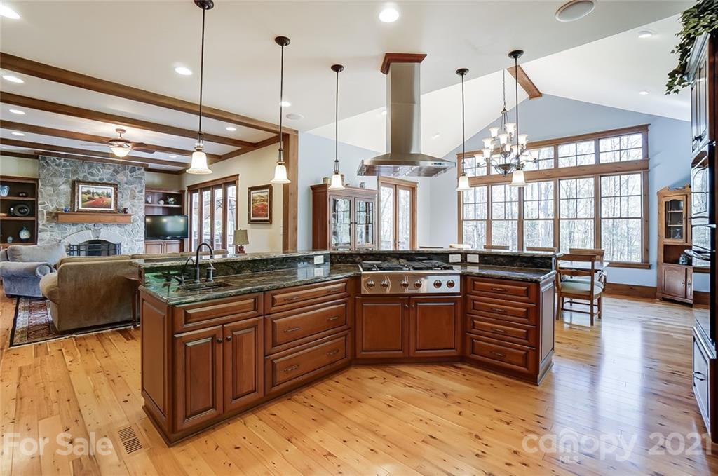 215 Eagle Cove Drive Cherryville, NC 28021 - Photo 13 of 48 a large kitchen with stainless steel appliances granite countertop a stove a sink and a wooden floors