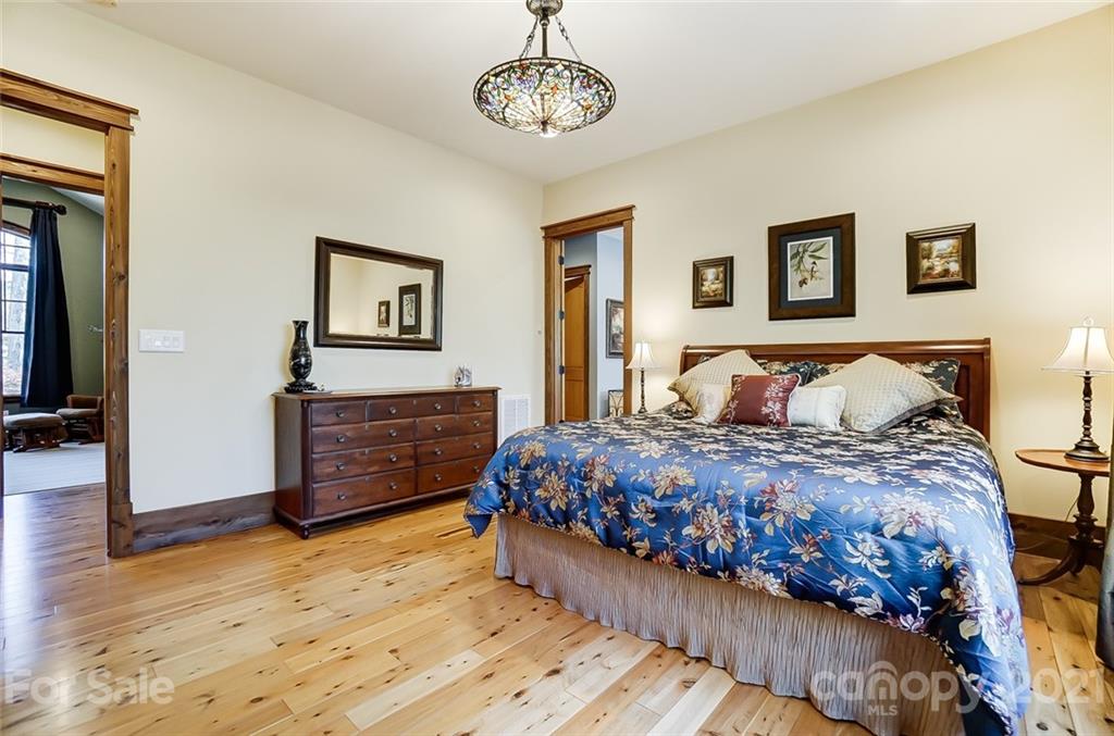 215 Eagle Cove Drive Cherryville, NC 28021 - Photo 18 of 48 a bedroom with a bed and wooden floor