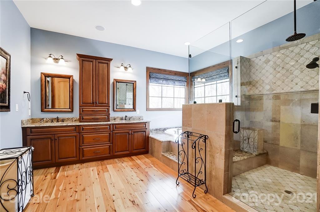 215 Eagle Cove Drive Cherryville, NC 28021 - Photo 19 of 48 a large bathroom with a granite countertop double vanity sink a mirror and a shower