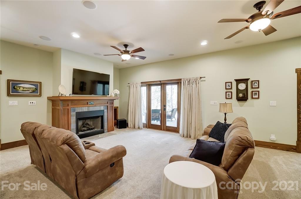 215 Eagle Cove Drive Cherryville, NC 28021 - Photo 26 of 48 a living room with furniture a fireplace and a flat screen tv