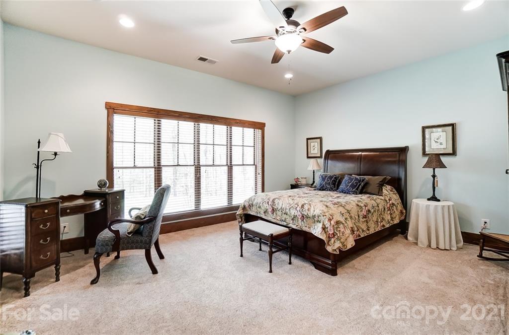 215 Eagle Cove Drive Cherryville, NC 28021 - Photo 31 of 48 a bedroom with a bed a desk and chair with windows