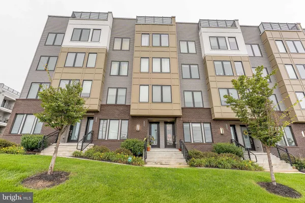 a front view of a residential apartment building with a yard