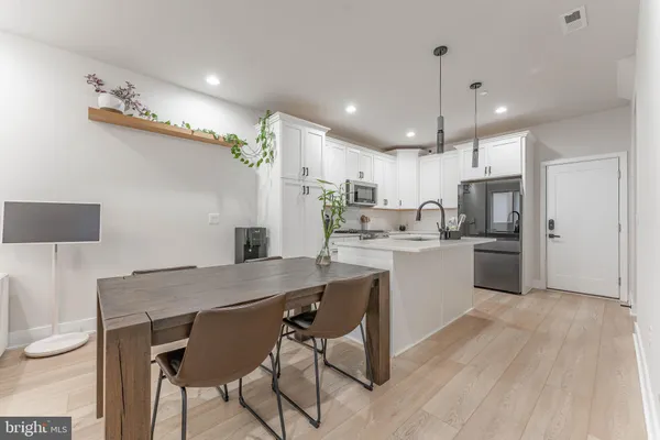 a kitchen with kitchen island a sink stainless steel appliances and cabinets