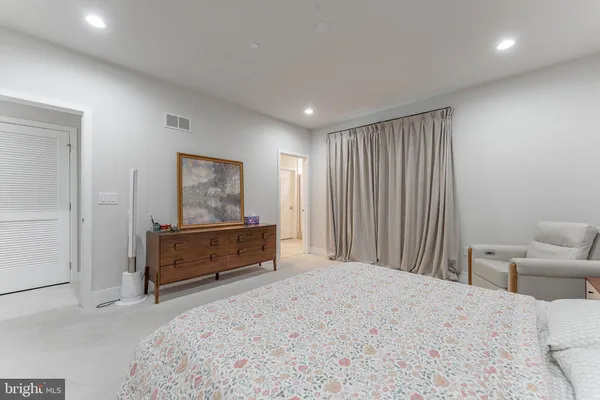 a bedroom with a bed and a night stand