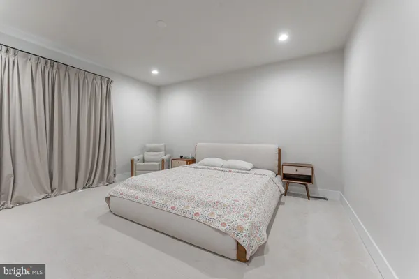 a spacious bedroom with a bed and a couch