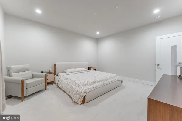 a spacious bedroom with a bed and a mirror