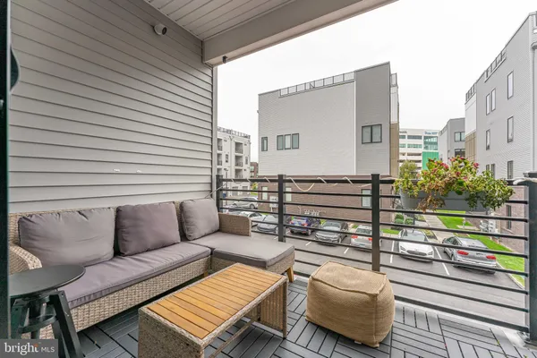 a view of a balcony with furniture and city view