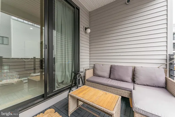 a room with furniture and a air conditioner vent