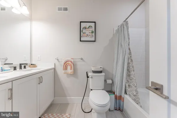 a white toilet sitting next to a bathroom sink