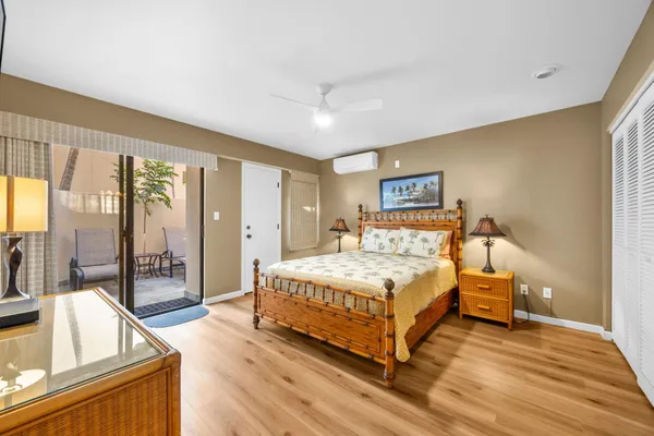 a bedroom with a large bed and a large window