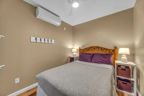 a bedroom with a bed and a night stand