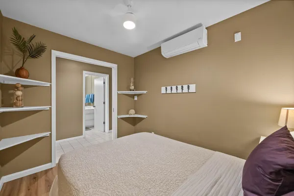 a bedroom with a bed and a painting on the wall