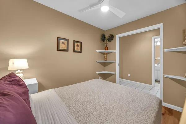 a bedroom with a bed and a lamp