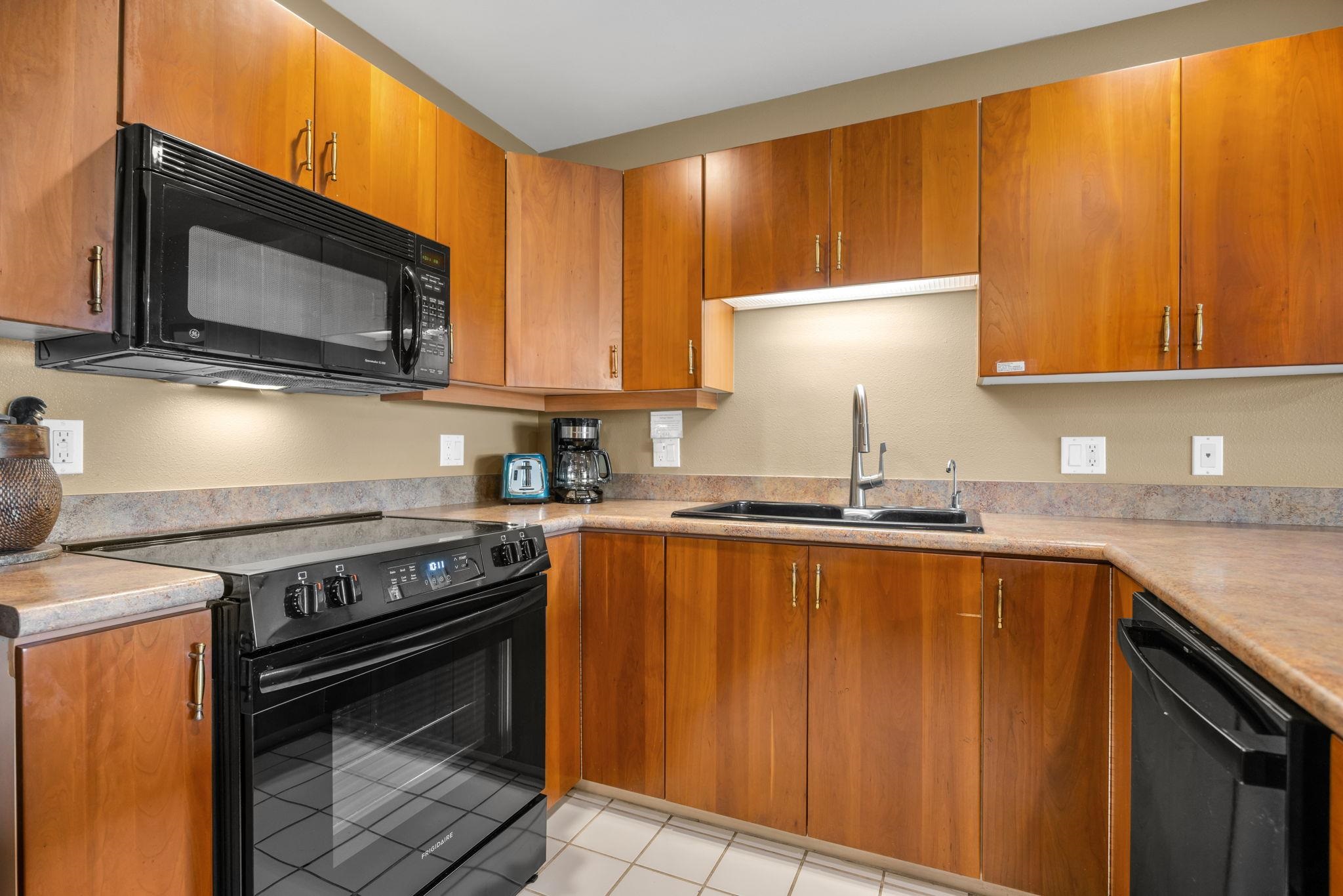 2777 South Kihei Road, Unit L105 Kihei, HI 96753 - Photo 2 of 48 a kitchen with stainless steel appliances wooden cabinets stove and microwave
