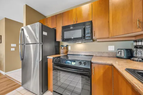 a kitchen with stainless steel appliances granite countertop a refrigerator stove and microwave