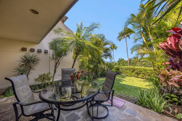 a view of a chairs and table in the patio